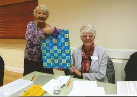 Stoneycroft Flower Club chairman Audrey Elliston presents a gift to Christine Linton on her retirement after eight years as secretary.
