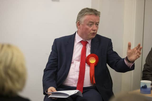 Labour's Parliamentary candidate for Hemel Hempstead Tony Breslin speaks to shopkeepers at a meeting in Warners End community centre