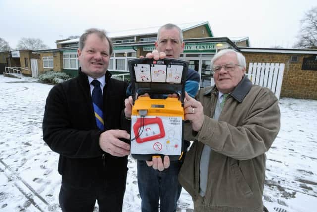 From left, Andrew Williams, centre manager Scott Boyer and Ron Tindall with the new defibrillator at Adeyfield Community Centre