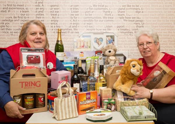 Sue Price, left, and Sue Clarke with some of the donated raffle prizes at Tesco in Tring