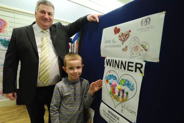 Eight years old William Berry wins the Valentine pavement painting prize at Marlowes Centre, Hemel Hempstead, with the manager
Vince Williams. PNL-150217-115448009