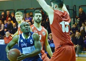 Storms diminutive guard Bode Adeluola drives past Readings 6ft 10ins centre Dan Carter