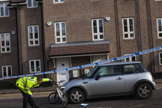 A police officer investigate's Monday's collision.  Photo: Elizabeth Dalziel