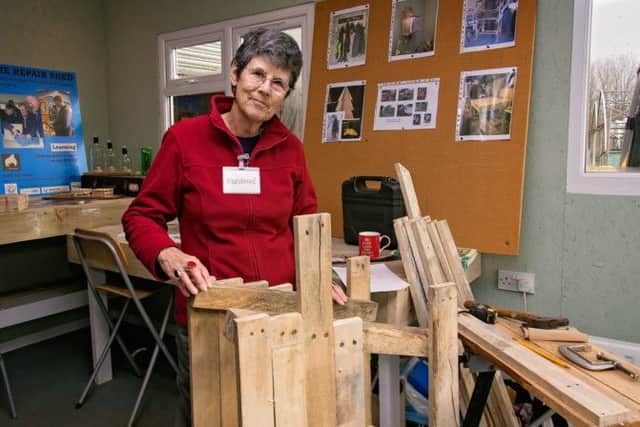 Adrienne Gear with the outdoor postbox she is making from recycled wooden pallets at the Repair Shed