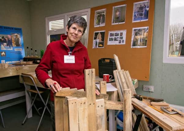 Adrienne Gear with the outdoor postbox she is making from recycled wooden pallets at the Repair Shed