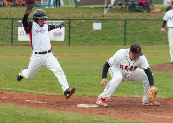 Robbie Almanzar (left) tries to get to first base in the 2013 National Championship semi-final. Picture (c) Richard Lee