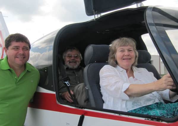 Joan Hands in the cockpit of a plane with husband Roger and her grandson, a qualified pilot
