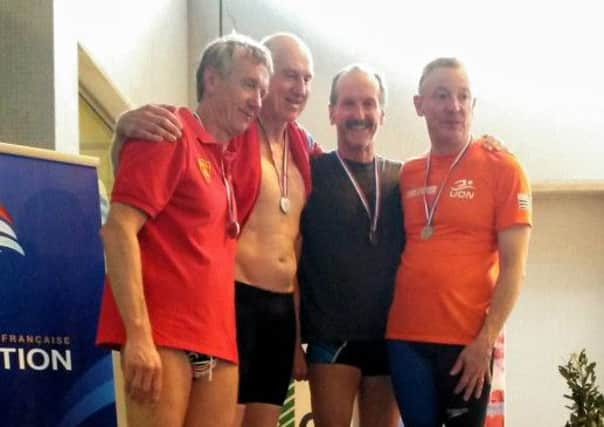 Mike Foskett, second from right, returned home with a five-medal haul