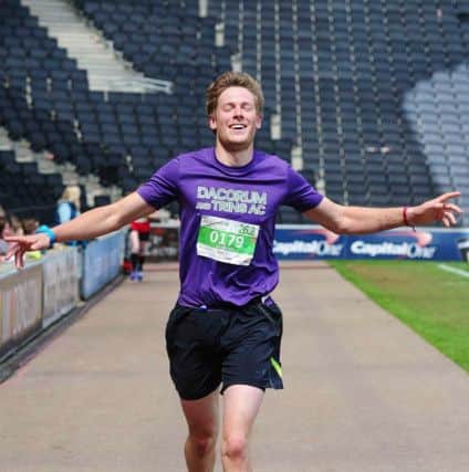 Dacorum & Tring AC's Duncan Hamilton crosses the finishing line at the Milton Keynes Marathon. Picture (c) Gary Mitchell