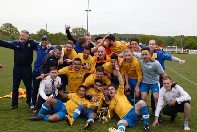 The Berkhamsted players and management team celebrate their cup win. Picture (c) Jackie Davis