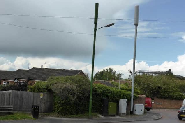 The grey 4G phone mast on Wingrave Road, Tring, which residents say was erected without consultation. Left, the camouflaged 3G phone mast with street lamp attached.