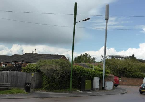 The grey 4G phone mast on Wingrave Road, Tring, which residents say was erected without consultation. Left, the camouflaged 3G phone mast with street lamp attached.