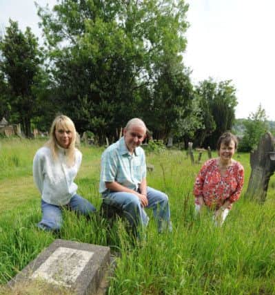 From left, Julia Watts, James Moir and Elaine Mercer with the 'Sutton grave' in Rectory Lane Cemetery, Berkhamsted