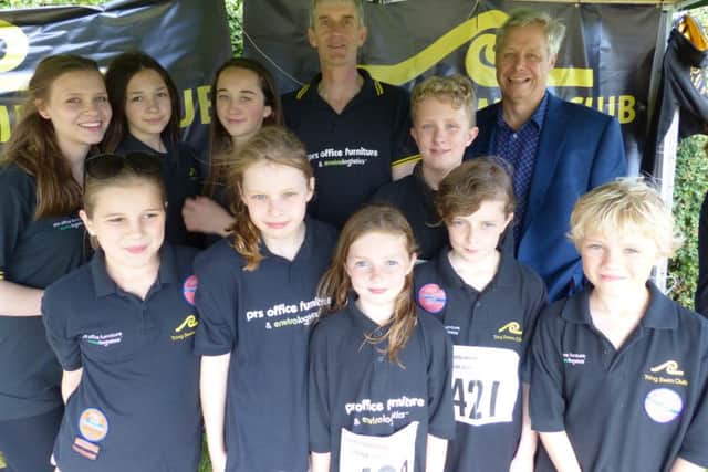 Peter Kemp, MD of PRS Office Furniture, with Tring Swimming Club chairman Mike Billingham and some of the young swimmers from the club