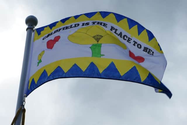 The flag designed by pupils was raised on the pole outside reception