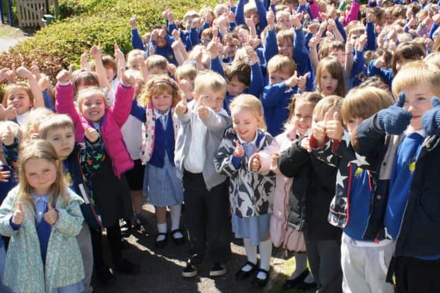 Goldfield pupils giving their school the thumbs up