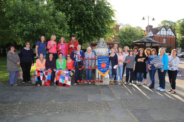 Members of Yarn Bomb Tring with some of their handiwork in Church Square, Tring, June 2015