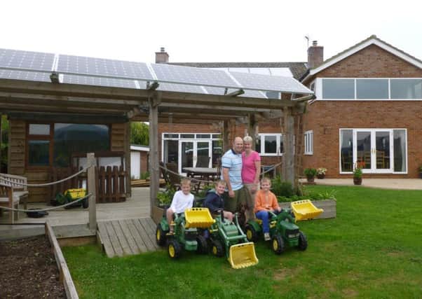 Neil Kennedy with wife Tracey, their sons James, 10, and twins Adam and Alex, eight, outside their eco-home in Marsworth, near Tring