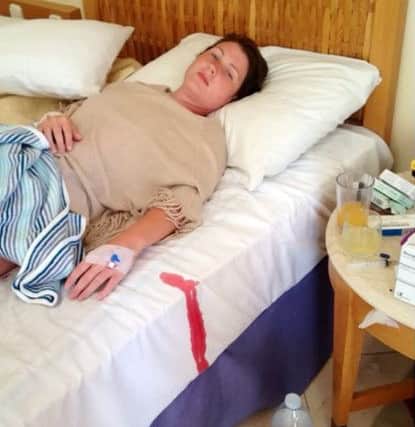Hayley lies ill in bed after a doctor failed three times to insert a cannula correctly.