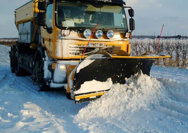 Gritters working in heavy snow.