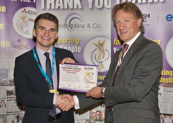 Oliver Floyd receiving his award from Hertfordshire deputy Lord Lieutenant Robert Voss.
