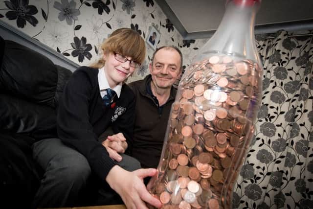 Lucy Collins (9) and dad Nik - Lucy has saved pennies in a giant Coke bottle to give to the Florence Nightingale Hospice. PNL-151120-201635009