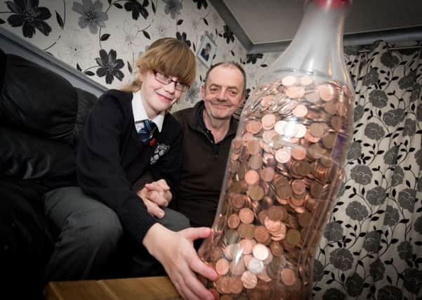 Lucy Collins (9) and dad Nik - Lucy has saved pennies in a giant Coke bottle to give to the Florence Nightingale Hospice. PNL-151120-201635009