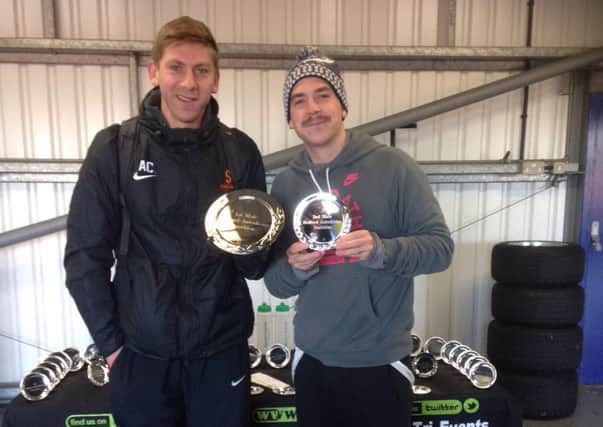 Andy Cracknell, left, with his prize for winning the Bedford Autodrome Duathlon