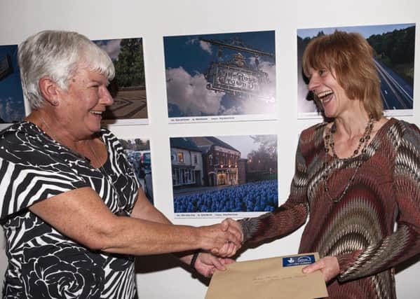 Roxanne Ransley presents Sarah Murrell with her prize for her image of the Olive Limes in Tring, centre. Photo by Stephen Kitchener.