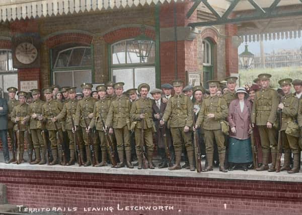 Colourised image of Hertfordshire Regiment men leaving Letchworth station in 1914 PNL-150123-152147001