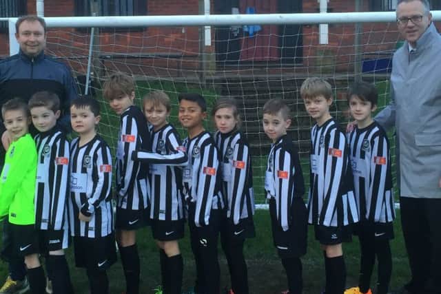 The Kings Langley FC U9s show off their new kit, donated by local McDonalds franchisee Alan Butchers (right)