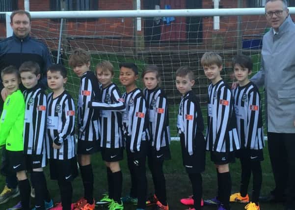 The Kings Langley FC U9s show off their new kit, donated by local McDonalds franchisee Alan Butchers (right)