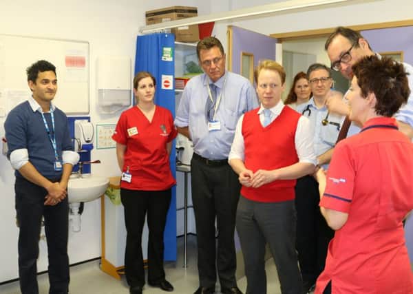 Parliamentary undersecretary for health Ben Gummer (pictured in tank top) during a visit to Watford General Hospital, January 2016