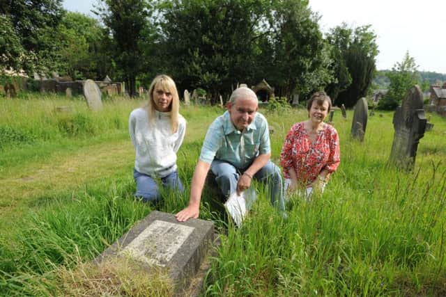 From left, Julia Watts, James Moir and Elaine Mercer with the 'Sutton grave' in Rectory Lane Cemetery, Berkhamsted