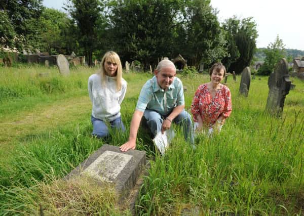 From left, Julia Watts, James Moir and Elaine Mercer with the 'Sutton grave' in Rectory Lane Cemetery, Berkhamsted