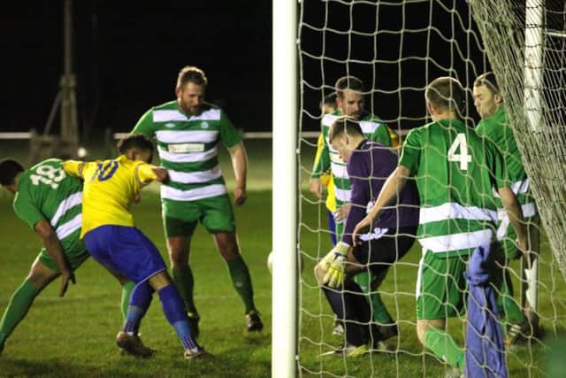 Berkhamsted scramble to get the ball away. Picture (c) Ray Canham