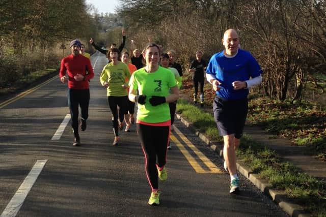 Samantha Sullivan and Rob Salt leading the training group up New Road in Berkhamsted