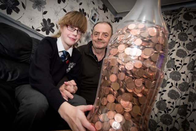 Lucy Collins (9) and dad Nik - Lucy has saved pennies in a giant Coke bottle to give to the Florence Nightingale Hospice. PNL-151120-201909009