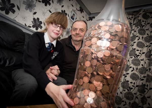 Lucy Collins (9) and dad Nik - Lucy has saved pennies in a giant Coke bottle to give to the Florence Nightingale Hospice. PNL-151120-201909009