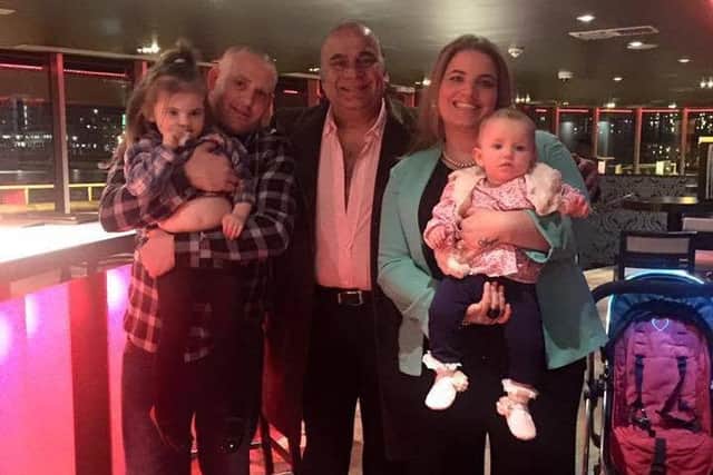 Daniel Baker, left, and Carmen Napper, right, at the Hotel Rafayel in London after Carmen proposed up The Shard on February 29. They are pictured with their daughters - Angel, three and Olivia, one - and hotel manager Iqbal latif