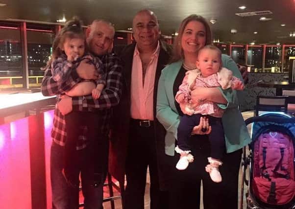 Daniel Baker, left, and Carmen Napper, right, at the Hotel Rafayel in London after Carmen proposed up The Shard on February 29. They are pictured with their daughters - Angel, three and Olivia, one - and hotel manager Iqbal latif