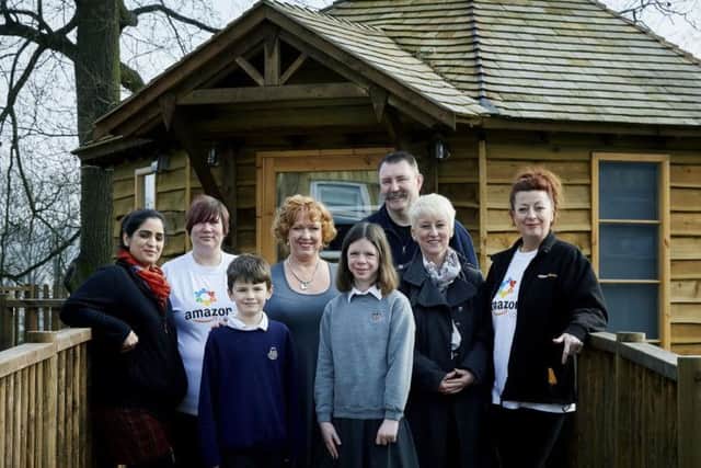 Amazon at The Collett School where they have donateed £1,000 towards computers. From left to right, Amazon associates Saima Ahsan, Heidi Kalsh, school project manager Gillian Lawton, Amazon associates Ian Hawkins, Jenny McKenzie, Ursula Weston. Front row, Harvey and head girl Rose
