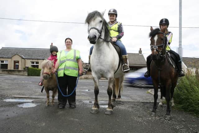 Joann Pollock complaining that drivers have no idea how to act when passing horses on the road. Lucy Corroon (7) on Halle; Lauren Hamilton on Merlin; Sophie Corroon (10) on Coco. NNL-160413-113707001