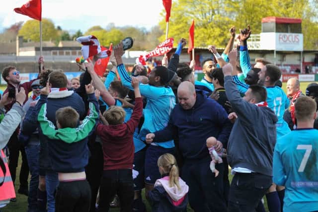 The Whitehawk fans and players celebrate their win. Picture (c) Terry Rickeard