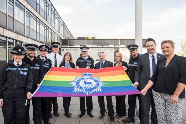 Senior Police Officer and force LAGLOs raising the Rainbow Flag at Police Headquarters. From left to right: Chief Inspector Claire Smith, PC Mark Smith (LAGLO), Force Lead for Sexual Orientation Chief Superintendent Matthew Nicholls, Sgt Steve Alison (LAGLO), PC Sam Bailey (LAGLO) Chief Constable Andy Bliss, PC Pat Davey (LAGLO), PC Beccy Driscoll (LAGLO), PC Matt Knowles (LAGLO) Deputy Lead for Sexual Orientation Detective Inspector Jason Thorne (LAGLO), DC Deborah Keating (LAGLO).