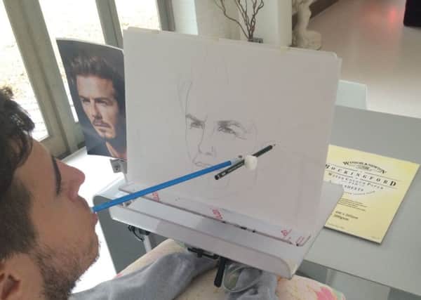 Henry Fraser at work, drawing a picture of David Beckham