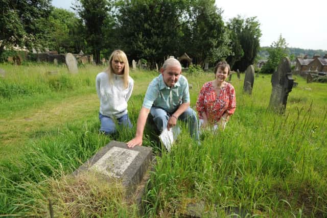 From left, Julia Watts, James Moir and Elaine Mercer with the 'Sutton grave' in Berkhamsted Cemetery.