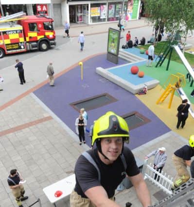 Hemel Hempstead firefighters staged a ladder climb in the Marlowes on Saturday for James Maguire aged three. Dan York in action.