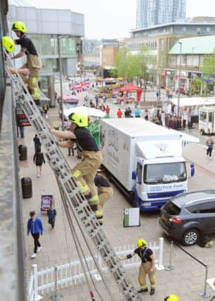 Hemel Hempstead firefighters staged a ladder climb in the Marlowes on Saturday for James Maguire aged three.