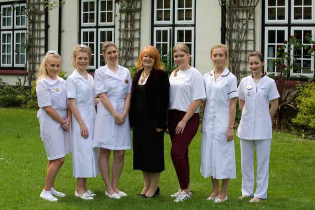 Champneys College principal Rachel Halling with therapists in uniforms from four decades